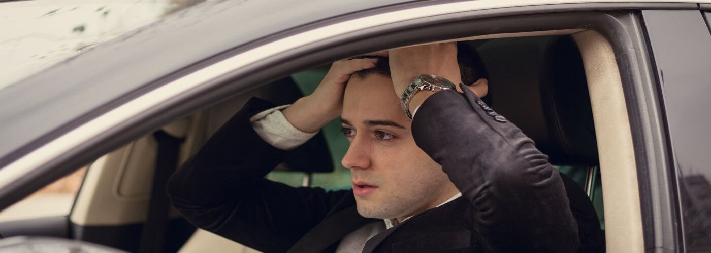 Man stressed out in his car